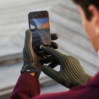 Green men's driving gloves with touchscreen technology.